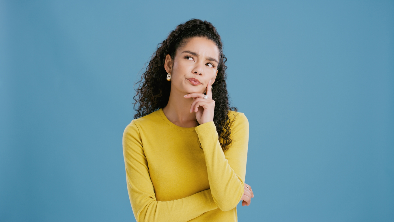 A young woman thinking about team building and group activities she and her group can enjoy in Central Illinois.