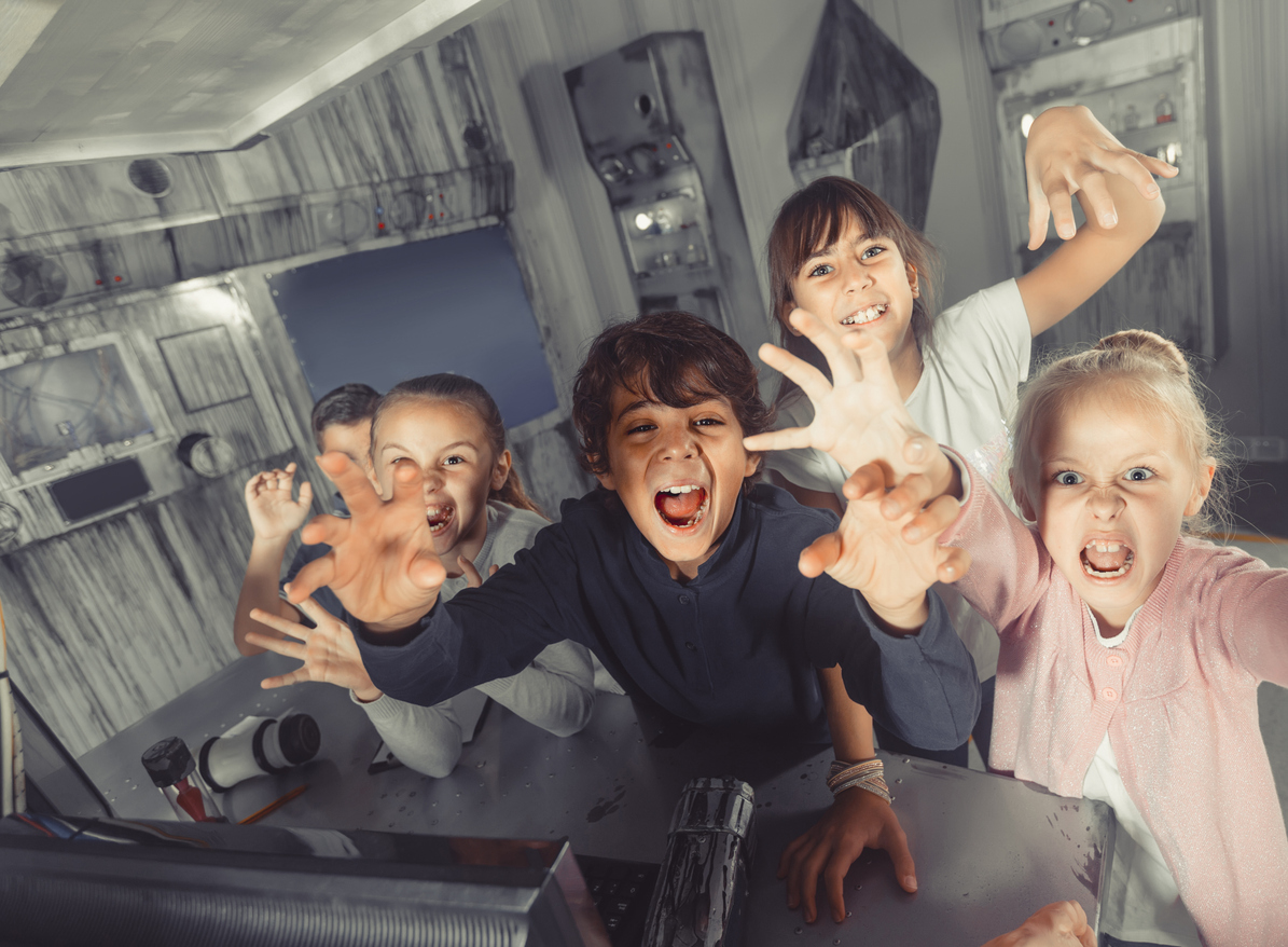 Kids enjoying a spooky, themed escape room at EscapeTown